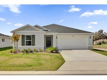 Charming one story home featuring a two car garage, a simple and well manicured front yard, and neutral paint at 3409 Narrows Dr, Lakeland, FL 33810