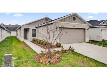 Charming one-story home with a two-car garage and beautiful landscaping at 8560 Caribbean Pine Way, Lakeland, FL 33809