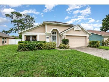 Charming single-story home featuring a well-maintained lawn and inviting curb appeal at 1611 Sand Key Cir, Oviedo, FL 32765
