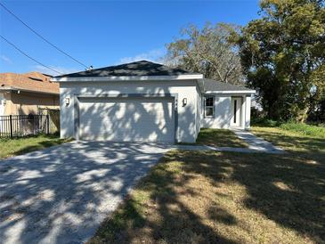 Charming single-story home with a two-car garage and modern architectural details at 4445 America St, Orlando, FL 32811