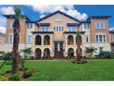 Beautiful Mediterranean style building with arched balconies, lush landscaping, and a vibrant green lawn at 2444 Lobelia Dr, Lake Mary, FL 32746