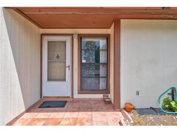 Charming front entrance with decorative details and tiled porch, giving curb appeal at 5875 Talavera St, Orlando, FL 32807