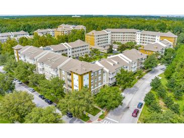 An aerial view of a condo complex surrounded by lush greenery and mature trees at 1401 Celebration Ave # 402, Celebration, FL 34747