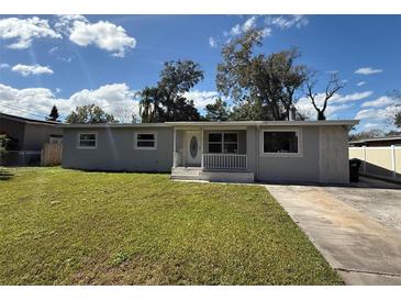 Charming single-story home with a well-manicured front lawn and inviting entrance at 2812 Dawley Ave, Orlando, FL 32806