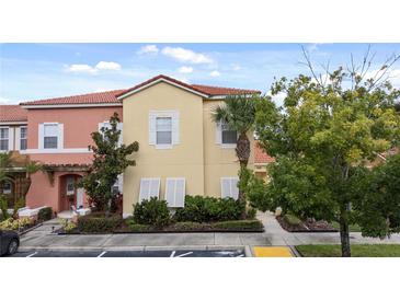 Charming multi-Gathering home with colorful facade, well-maintained landscaping, and a beautiful red tile roof at 126 Pompano Beach Dr, Kissimmee, FL 34746