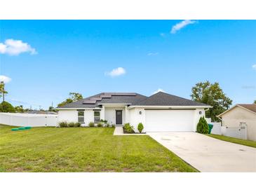 Charming one-story home with a well-manicured lawn and a two-car garage at 1302 Belmar Ter, Deltona, FL 32725