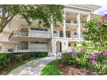 Exterior of condo building with landscaped grounds and walkway at 700 Melrose Ave J 1 Ave # J1, Winter Park, FL 32789