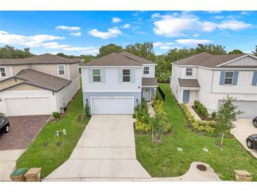 Charming two-story home boasts a well-manicured lawn, two-car garage, and inviting curb appeal at 1001 Rivers Crossing St, Clermont, FL 34714