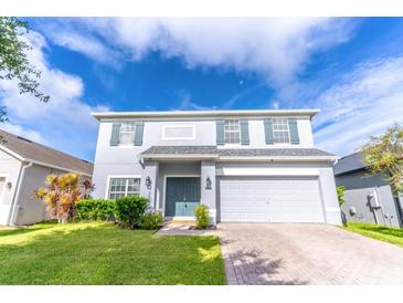 Two-story house with gray siding, gray shutters, and a two-car garage at 306 Mirasol Ln, Orlando, FL 32828