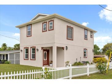 Charming two-story home with a well-manicured lawn and white picket fence offers curb appeal at 821 E Story Rd, Winter Garden, FL 34787