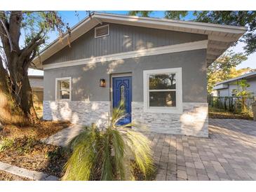 Charming home featuring stone accents, updated siding and a vibrant blue front door at 1321 Cloverlawn Ave, Orlando, FL 32806