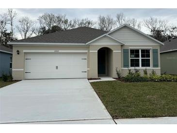 Two-story home with white siding, gray roof, and a two-car garage at 2008 Red Rock Rd, New Smyrna Beach, FL 32168