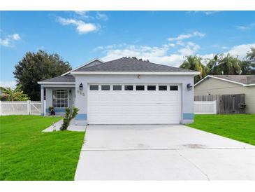 Newly renovated one-story home with a two-car garage and manicured lawn at 805 Nelson Dr, Kissimmee, FL 34758