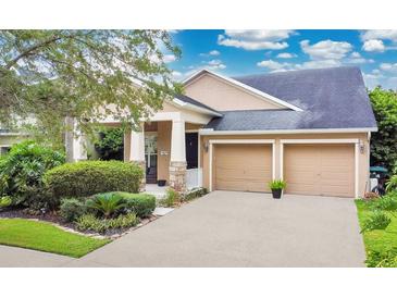 Charming single-Gathering home featuring a two-car garage, manicured landscaping, and a welcoming front porch at 4409 Cleary Way, Orlando, FL 32828