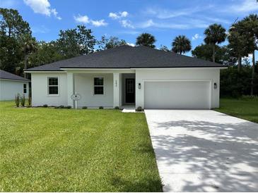 Charming single-story home with a well-manicured lawn and a spacious two-car garage at 282 Kimble Ave, Oviedo, FL 32765