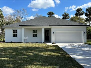 Charming single-story home featuring a manicured lawn and attached two-car garage at 282 Kimble Ave, Oviedo, FL 32765