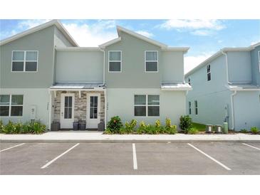 Charming townhome featuring a stone facade, double front doors, and a well-maintained landscape at 7944 Formosa Valley Pl, Kissimmee, FL 34747