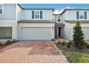 Charming light blue townhome with a brick paver driveway and a spacious two-car garage at 4308 Ranch House Rd, Saint Cloud, FL 34772