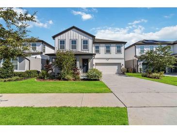 Two-story home with gray siding, landscaping, and a two-car garage at 720 Split Hoof Dr, Saint Cloud, FL 34771