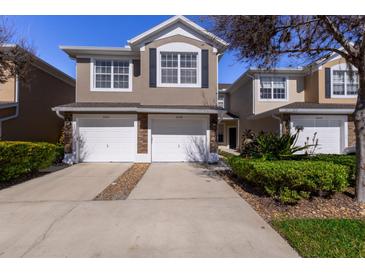 Two-story townhome with two-car garage and landscaped front yard at 5058 Maxon S Ter # 108, Sanford, FL 32771