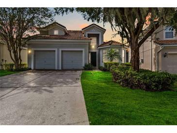 Two-story house with a two-car garage and landscaped lawn at 2616 Bowring St, Kissimmee, FL 34747