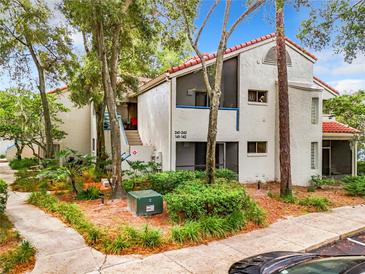 Two-story condo building with Spanish-style architecture and lush landscaping at 1000 Winderley Pl # 241, Maitland, FL 32751