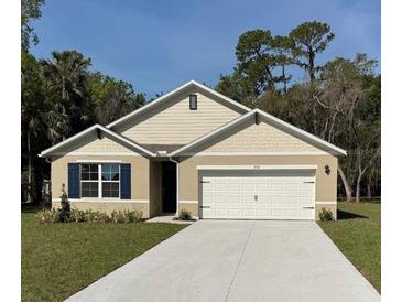 Charming single-story home featuring a well-manicured lawn, a two-car garage and craftsman-style accents at 1552 Lakeside Dr, Deland, FL 32720