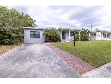 Charming single-story home features a well-maintained lawn, brick walkway, and lovely curb appeal at 2819 Pembrook Dr, Orlando, FL 32810