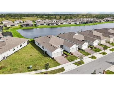 Aerial view of homes with lake access in a new community at 2952 Cherry Blossom Loop, Saint Cloud, FL 34771