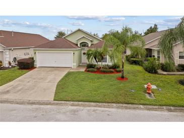 Charming single-Gathering home featuring a well-manicured lawn and attached two-car garage at 246 Kimberly Point Dr, Davenport, FL 33837