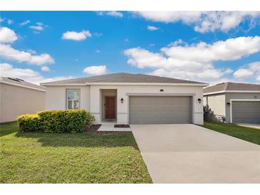 Single-story home with attached garage and landscaping at 3544 Forster Ave, Leesburg, FL 34748