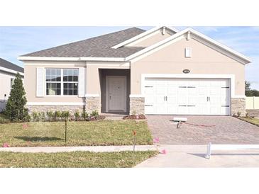 New construction home with two-car garage and landscaping at 2619 Great Heron Ave, Saint Cloud, FL 34773