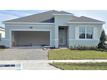 New construction home with two-car garage and landscaping at 2643 Great Heron Ave, Saint Cloud, FL 34773