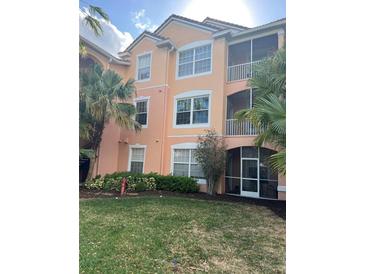 Beautiful three-story building with screened in patios and lush landscaping around the property at 13500 Turtle Marsh Loop # 823, Orlando, FL 32837