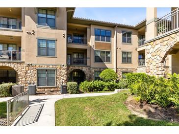 Exterior of building with landscaping and walkway at 906 Charo Pkwy # 433, Davenport, FL 33897