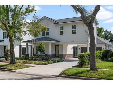 Charming two-story home with landscaped yard, portico, and driveway at 1020 W Princeton St, Orlando, FL 32804