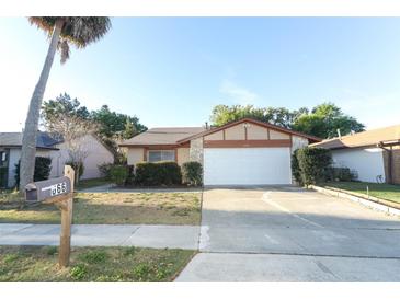 Charming single-Gathering home with a well-manicured lawn and attached two-car garage at 666 Sausalito Blvd, Casselberry, FL 32707