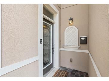 Inviting front entry featuring decorative glass door, stucco walls, and classic black hardware at 41 E Spruce St, Orlando, FL 32804