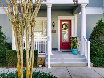 Inviting front entrance with red door, white columns, and landscaping at 535 Crimson Ln, Winter Springs, FL 32708