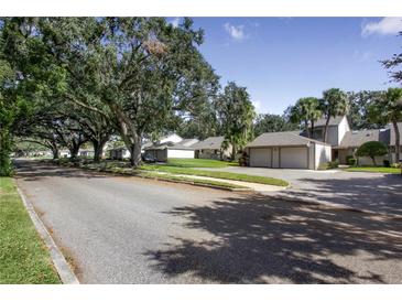 Residential street lined with lush trees and townhomes at 543 Warrenton Rd # 543, Winter Park, FL 32792