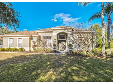 Single-story home with attractive landscaping and a welcoming front entrance at 9868 Montclair Cir, Apopka, FL 32703