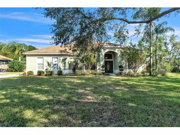 Single-story house with a well-maintained lawn and landscaping at 9868 Montclair Cir, Apopka, FL 32703