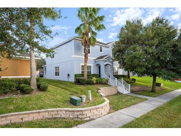 Charming two-story home with blue siding, landscaped yard, mature trees, and inviting curb appeal at 621 Brandy Oaks Loop, Winter Garden, FL 34787