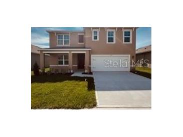 Charming two-story home featuring a welcoming front porch and a two car garage at 3558 Sandalwood Isle Way, Ocoee, FL 34761