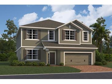 Two-story house with gray siding, two-car garage, and landscaping at 1169 Basalt Ln, Sanford, FL 32771