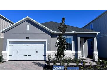 Charming single-story home showcasing a gray exterior, white trim, and a well-manicured front yard at 1173 Basalt Ln, Sanford, FL 32771