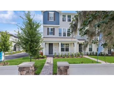 Charming, two-story townhome with a landscaped front yard and welcoming entryway at 2171 E South St # 5, Orlando, FL 32803