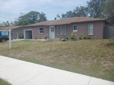 Charming single-story home featuring a well-maintained front yard and an attached garage at 16 N Lancelot Ave, Orlando, FL 32835