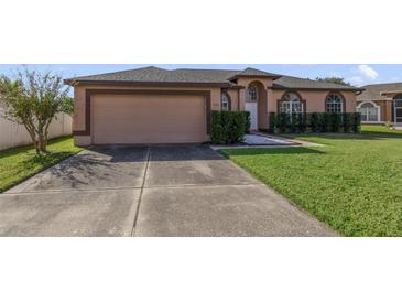 Charming single-story home with a two-car garage and well-maintained lawn at 2686 Maxwell W Ct, Kissimmee, FL 34743