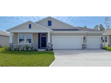 Charming single-story home with a three-car garage and a well-manicured front lawn at 308 Barebow Ln, Ormond Beach, FL 32174